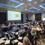 View of audience looking towards the presenter and large screen at the Future of Severe Asthma Care event July 2023